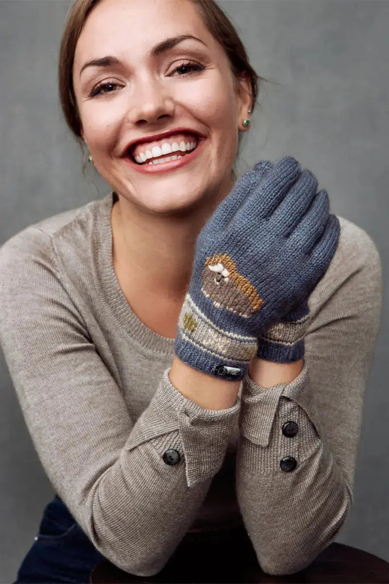 A woman wearing a blue Qiviuk, Merino & Silk Muskox ladies gloves in light blue by Qivuk Boutique