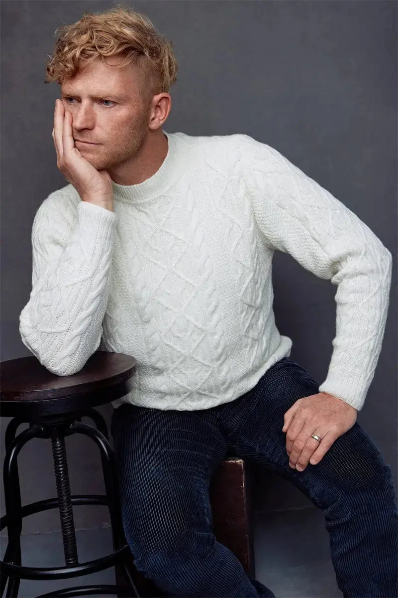 A man in a white Fisherman Unisex Pullover Sweater Merino by Qiviuk Boutique