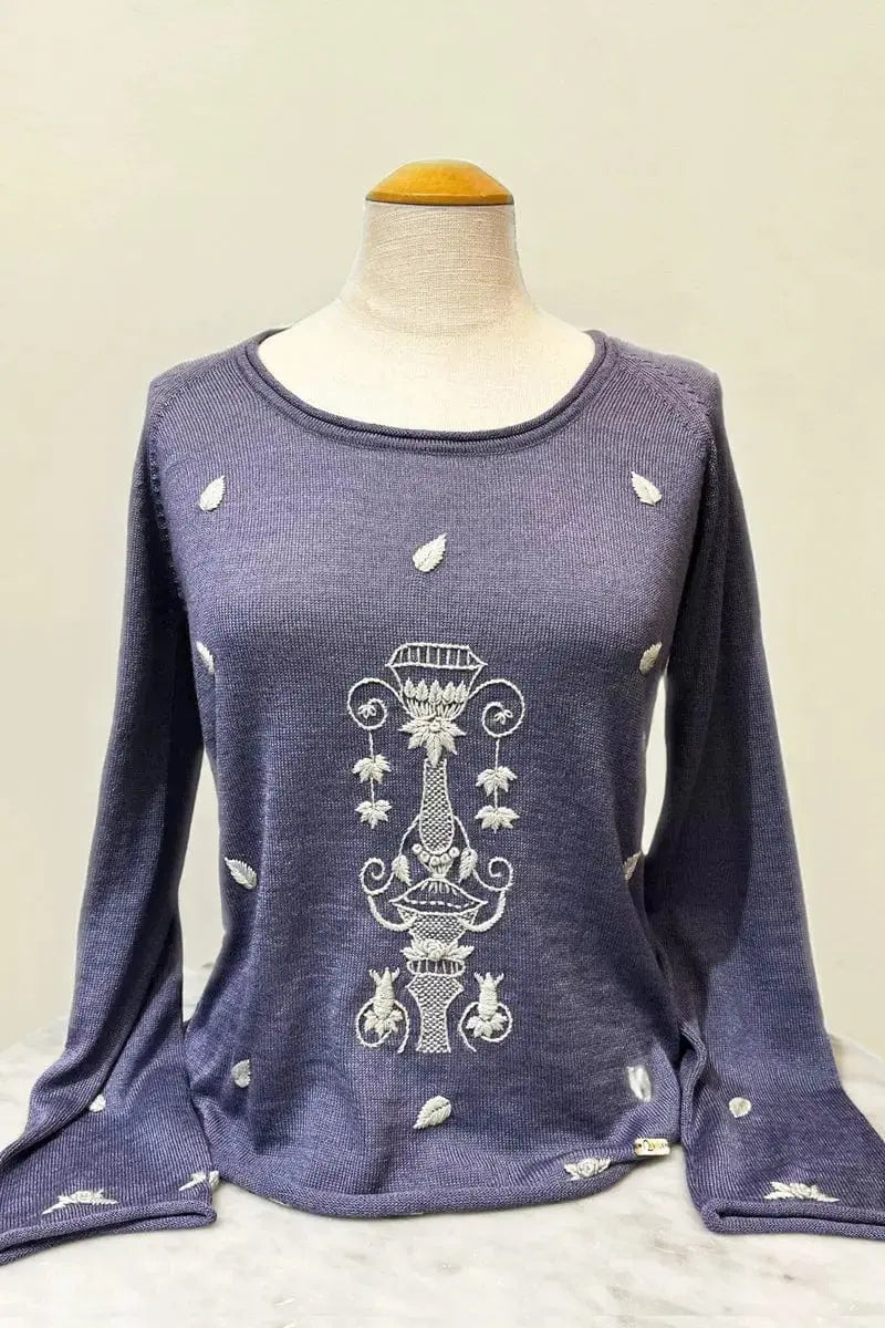 A display of a blue with embrodery Jarron Womans Pullover shirt made with Alpaca & Silk in Lilac by Qiviuk Boutique