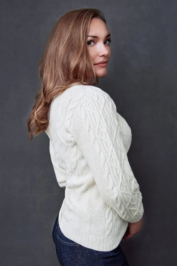 Side view of a woman in a White Fisherman Unisex Pullover Merino by Qiviuk Boutique