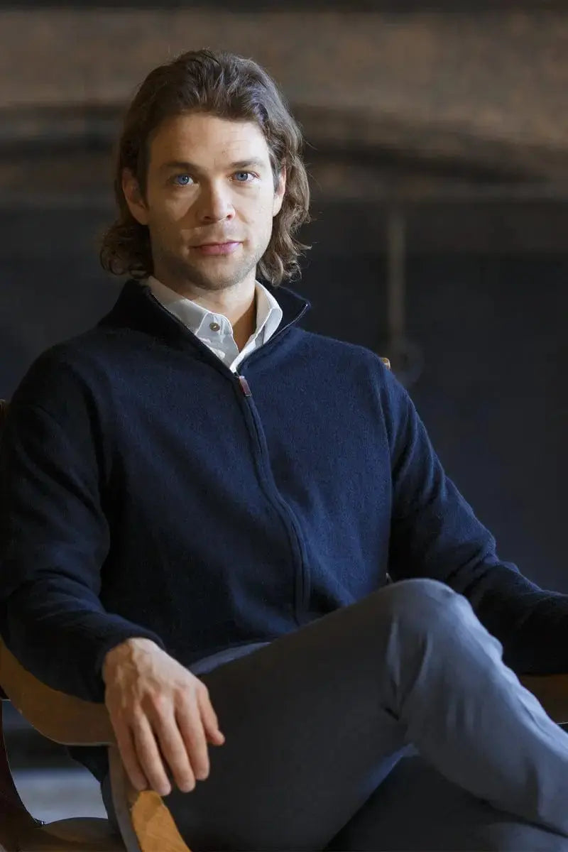 Seated Qiviuk Gabo men's cardigan in black by Qiviuk Boutique