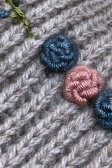Ac lose up phot of the knot of a Qiviuk, Merino & Silk Rosaly woman's pullover sweater in natural by Qiviuk Boutique